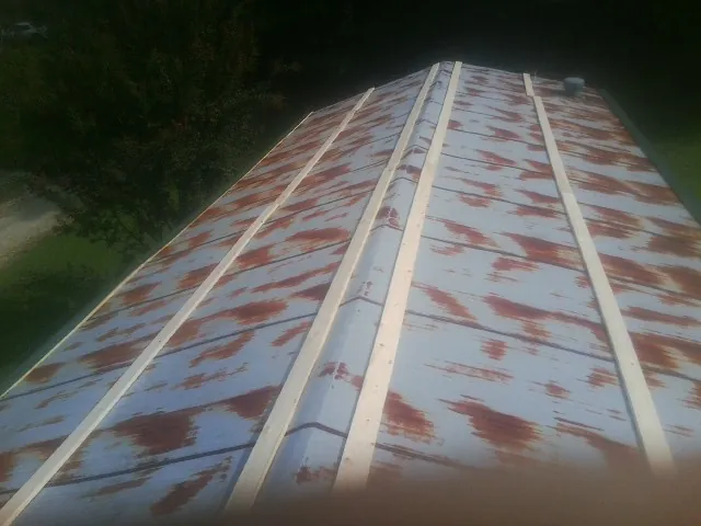 Rusted metal roof panels with new wood purlins before replacement — Storm Damage Roof Repair in Cantrall by Roofing Brothers